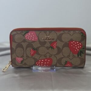 COACH Long Zip Around Wallet featuring signature canvas base and Wild Strawberry